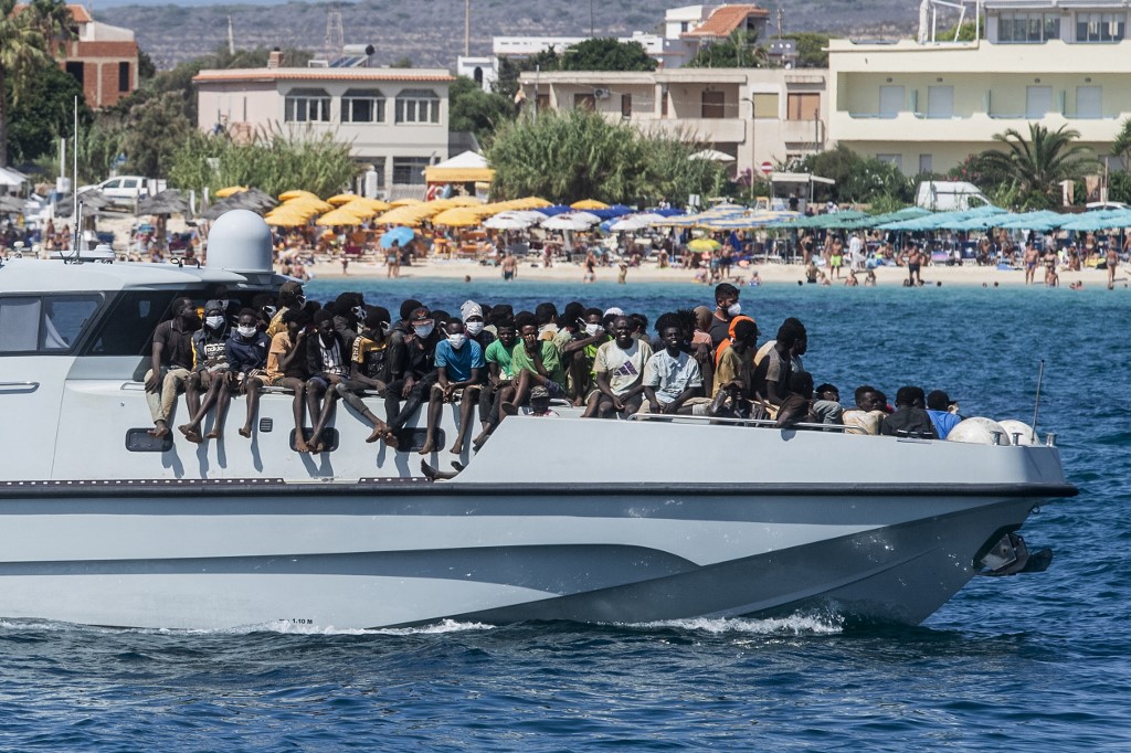 New migrants arrive on a Guardia di Finanza ship, in the harbour of Italian island of Lampedusa, on September 15, 2023.