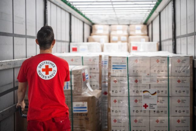 An employee of the German Red Cross (DRK) loads relief goods into a truck in Berlin.