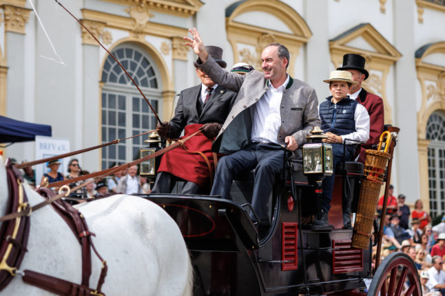 Hubert Aiwanger, Minister of Economic Affairs and State Chairman of the Free Voters in Bavaria (M), on a carriage at a historic horse and carriage gala at Schleißheim Palace in Bavaria on Sunday.