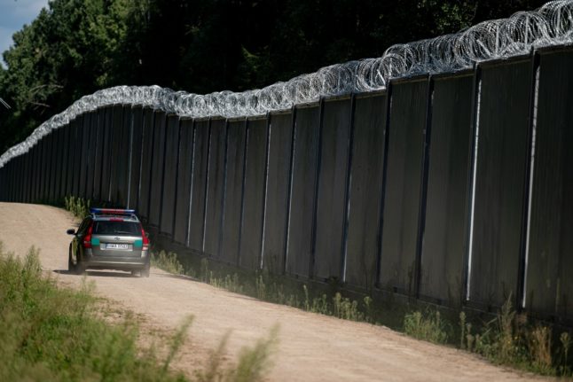 Police cars patrol the Polish border.
