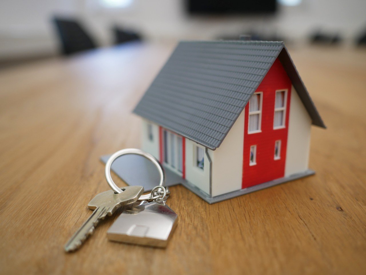 A miniature house with new house keys. 