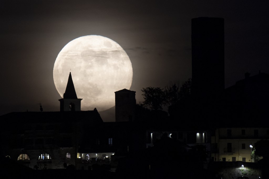 A "Super Blood Moon" rises behind the castle of the village of Castiglione Falletto in northwestern. Italy.