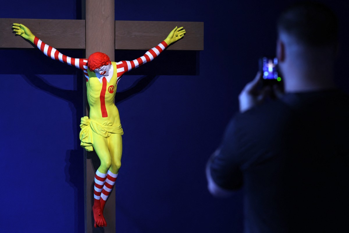 Visitors look at "McJesus" by Finnish artist Jani Leinonen, at the Forbidden Art Museum in Barcelona 