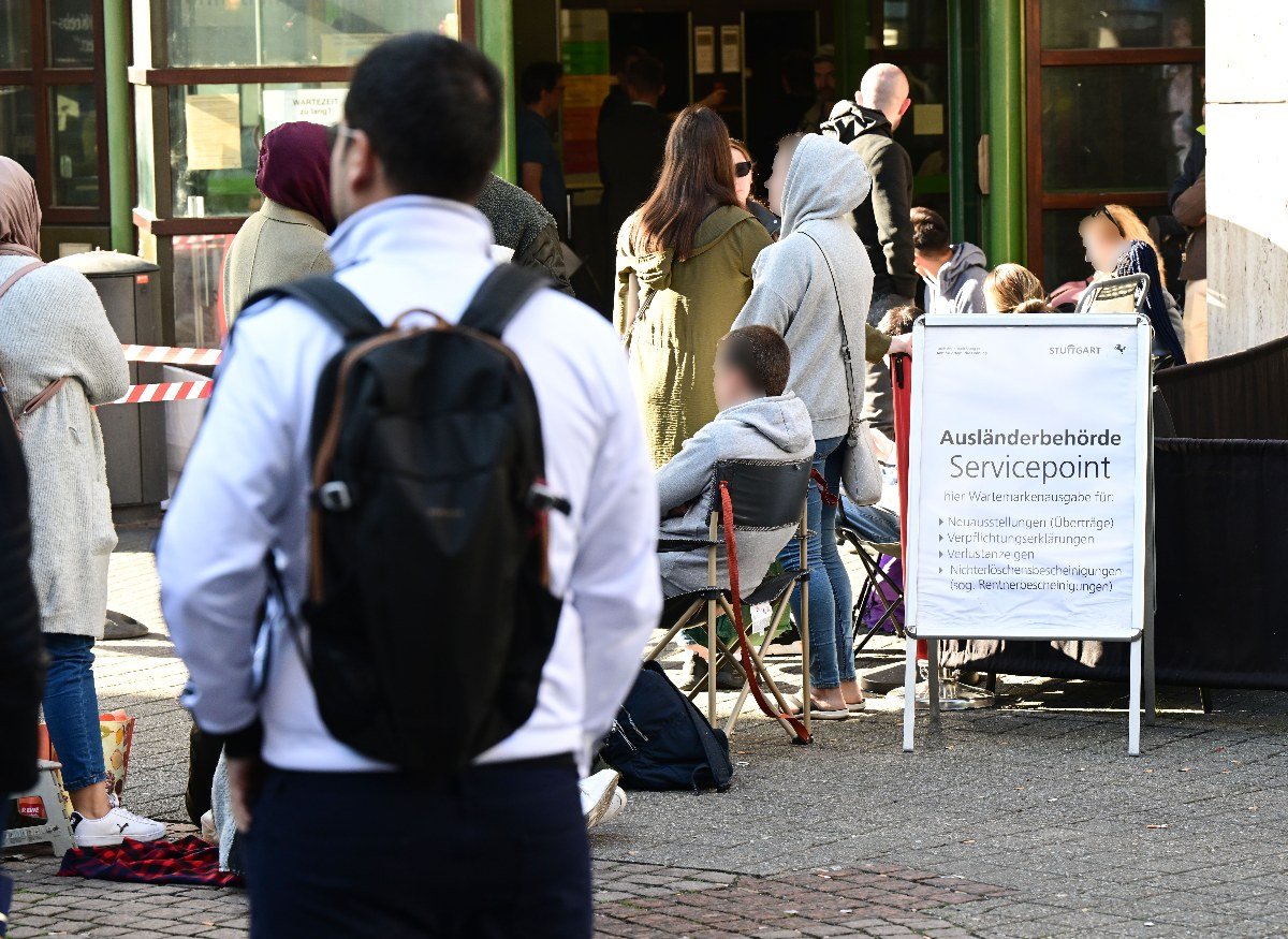 People wait at the Stuttgart immigration office hours before it opens.