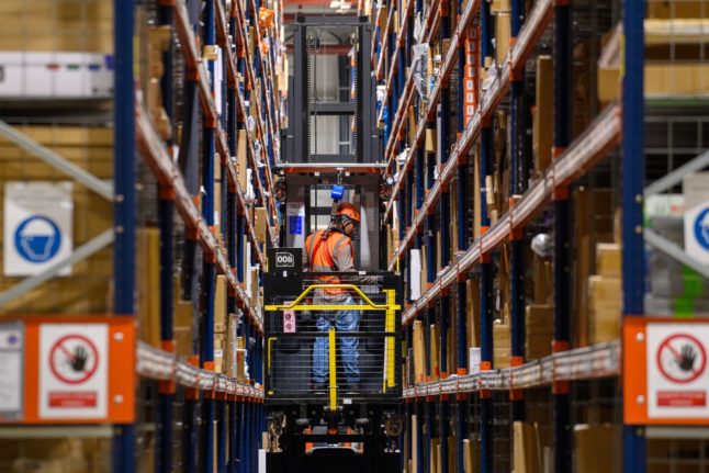 A worker stacks shelves at an Amazon logistics centre