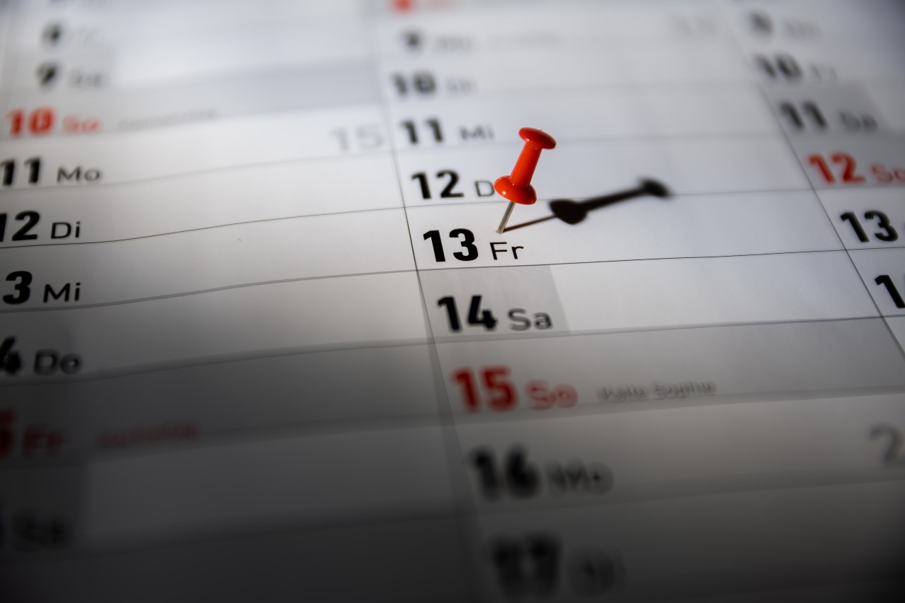 A calendar with Friday 13th marked with a pin.
