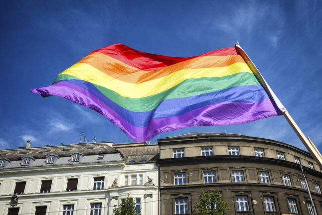 An LGBT flag flies.