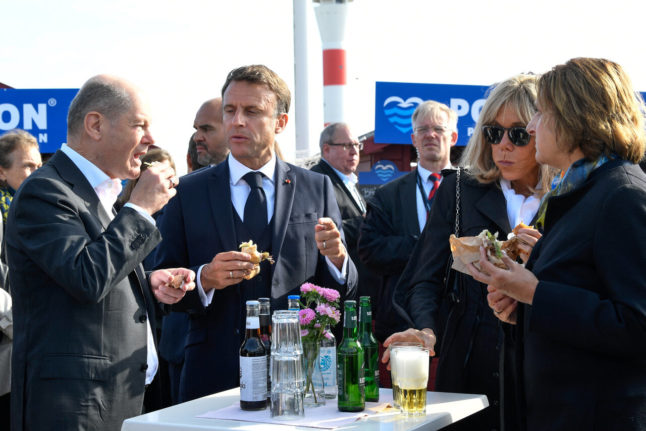 Chancellor Olaf Scholz, French President Emmanuel Macron, Brigitte Macron and Scholz' wife Britta Ernst eat Fischbrötchen in Hamburg.