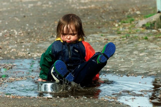 Child playing in a puddle