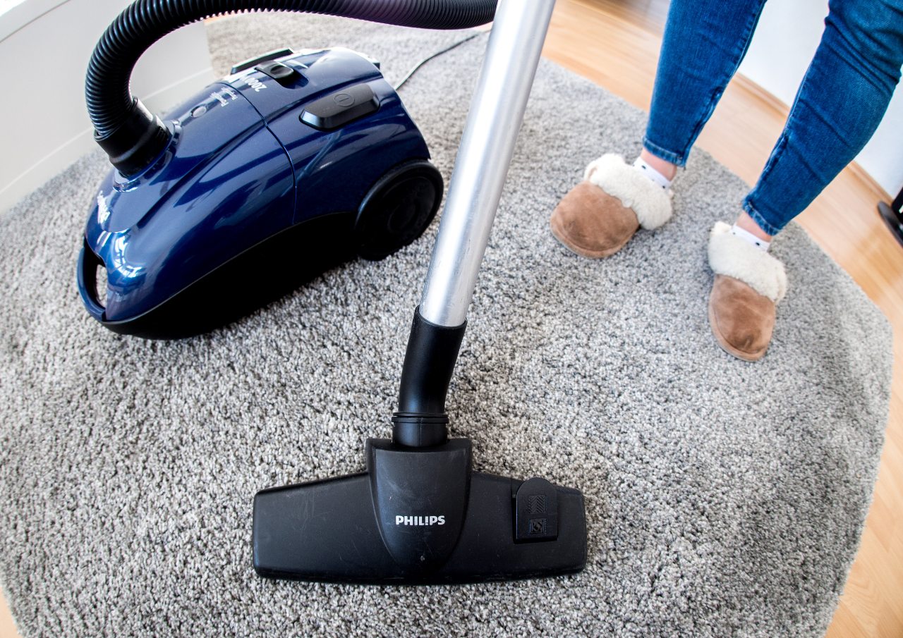 A woman vacuums her flat in Germany.