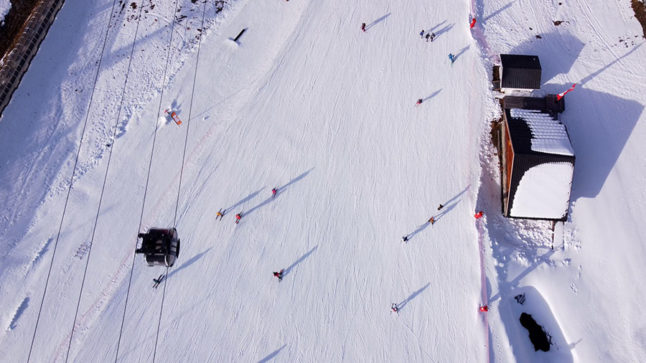 An aerial view taken in November 2021 shows skiers on the slopes at Val Thorens ski resort, in the French Alps, south-eastern France.