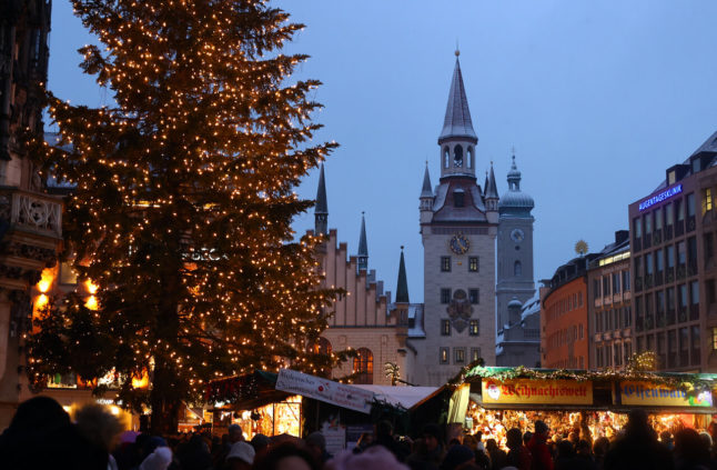 People enjoy a Christmas market in Munich in December 2022.