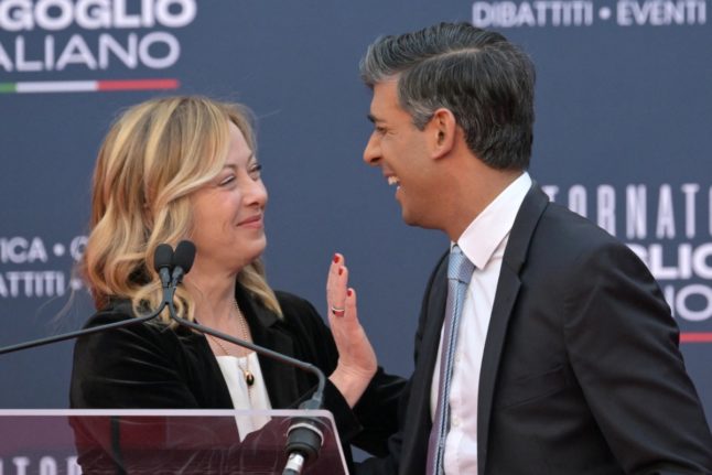 British Prime Minister Rishi Sunak jokes with Italian Prime Minister Giorgia Meloni during the Atreju political meeting organised by the young militants of Italian right wing party Brothers of Italy