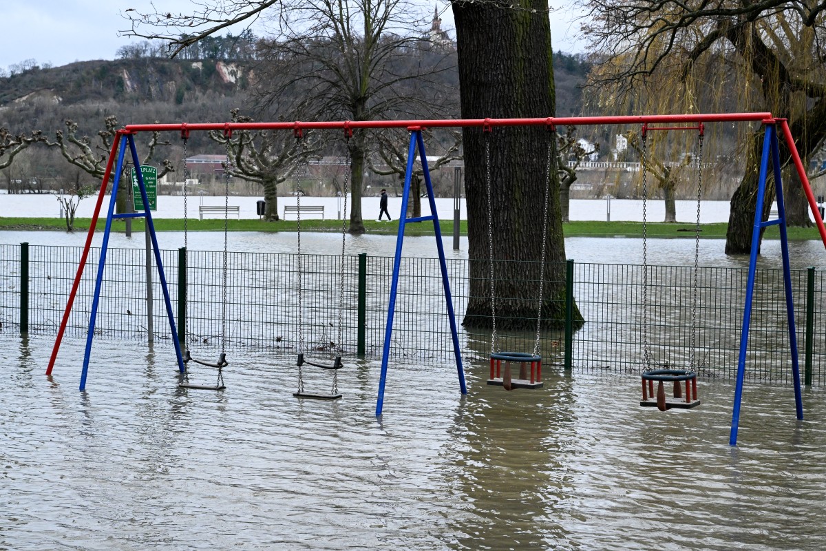 Swings on a children's playground are flooded as the Rhein river overflows its banks in Ruedesheim am Rhein, western Germany, on December 29, 2023.