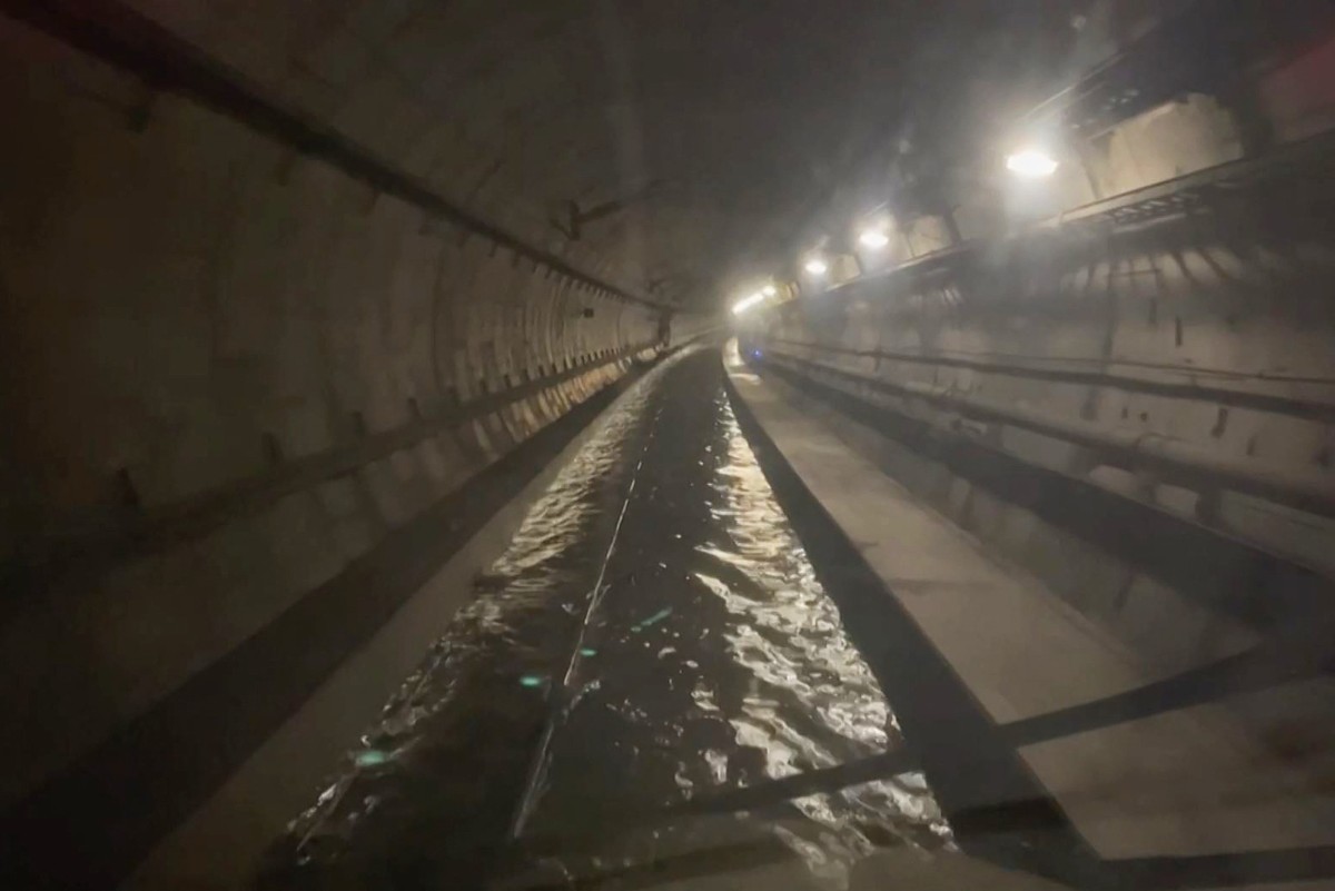 A frame grab taken from a handout video footage posted on the Southeastern Railway's X account on December 30, 2023  shows flooded water in a tunnel used by Eurostar trains, near Ebbsfleet International station in Kent