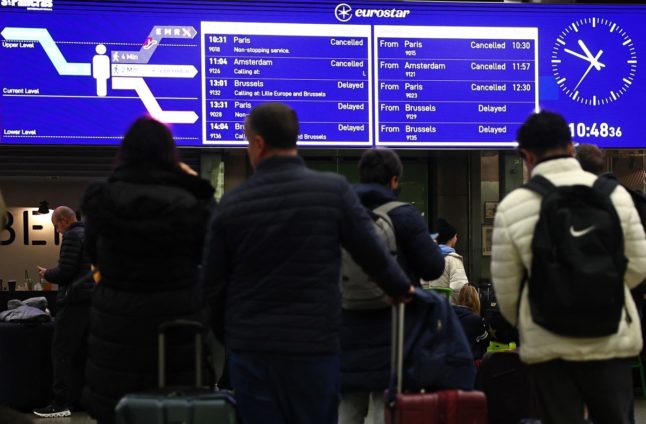 Eurostar arrivals and departures are seen cancelled and delayed on an information board at St Pancras station in London on December 30