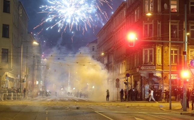 People let off fireworks in the street in Leipzig