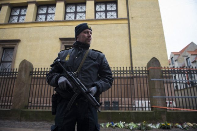 A police officer stands guard outside the synagogue Krystalgade in Copenhagen