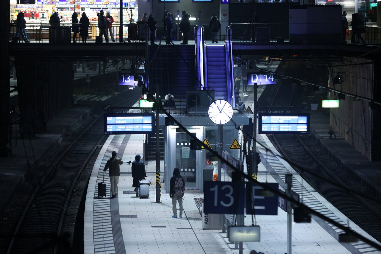 Some passengers stand on a platform in Hamburg on Friday. 