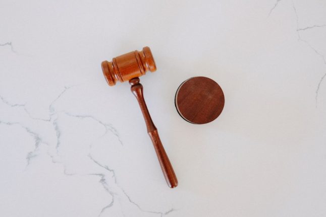Pictured is a gavel and hammer.