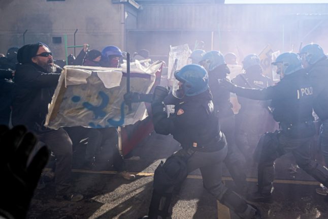 Demonstrators clash with riot police during a protest against the presence of an Israeli pavillion at Vicenzaoro
