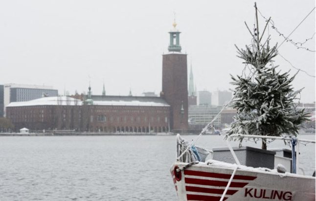A Christmas tree covered with snow is seen on a boat in Sodermalm, Stockholm, Sweden