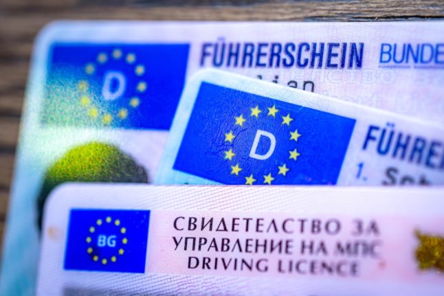 EU driving licences on a table.