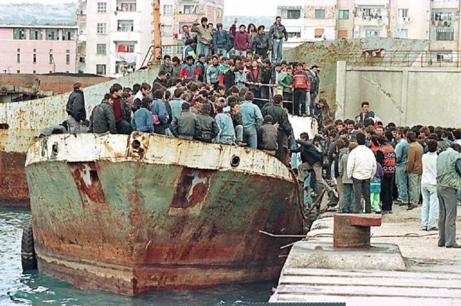 Nearly 1,000 desperate Albanians stand aboard an abandoned ship on March 17, 1997, waiting for a possible departure for Italy.