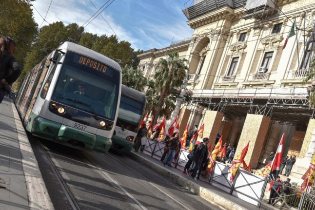 A tram drives past. (Photo by ANDREAS SOLARO / AFP)