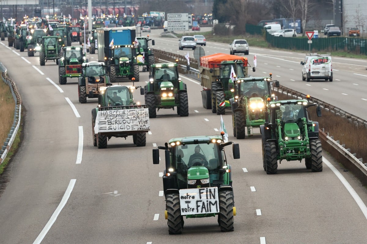 Farmers drive their tractors during a protest called by local branches of major farmer unions FNSEA and Jeunes Agriculteurs, blocking the A35 highway with tractors near Strasbourg, eastern France,