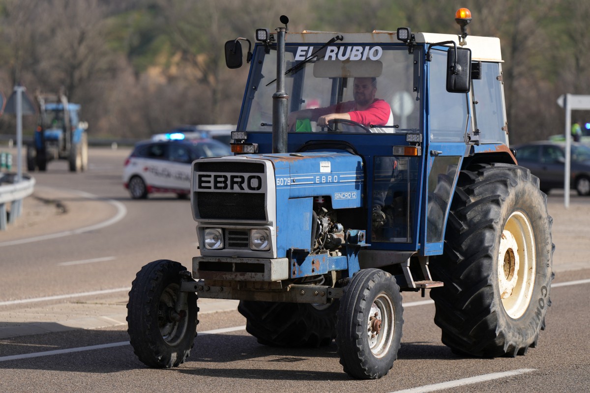 A Spanish farmer drives a tractor along the road during a protest in demand of fair conditions for the agricultural sector, in Leon, northern Spain