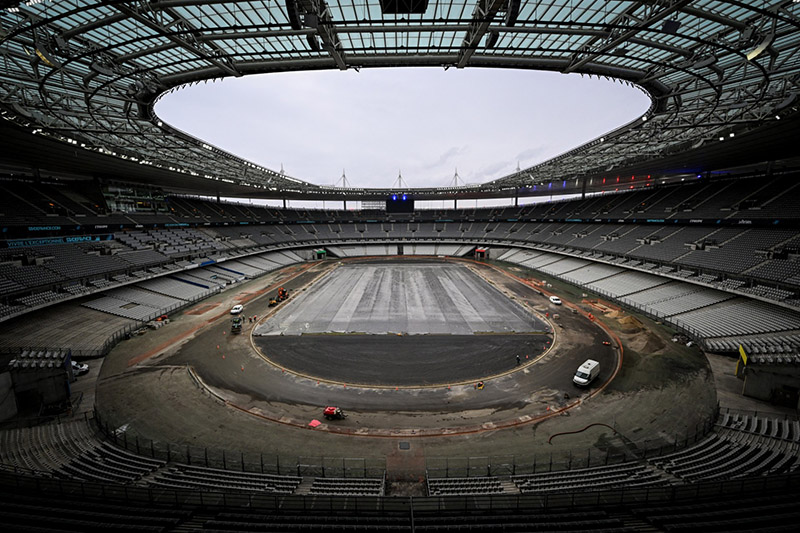 This photograph taken on February 8, 2024 shows employees working to adapt the Stade de France in view of the 2024 Olympic Games, in Saint-Denis, Paris' suburb. 
