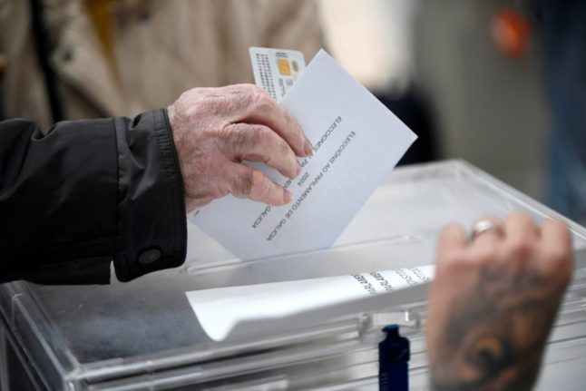 A voter casts a ballot in Pontevedra, on February 18, 2024 during the regional elections in Galicia