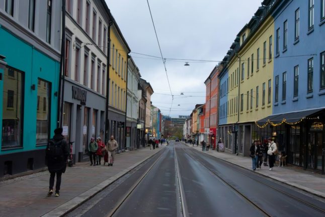 Pictured is a street in Oslo's Grunneløkka district that is full of shops and bars.