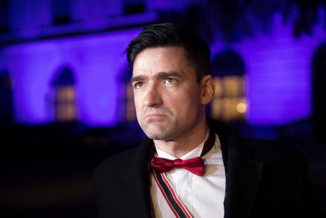 Martin Sellner, former spokesman of the far-right Identitarian movement, speaks to journalists in front of the Hofburg Palace in Vienna upon arrival at the so-called Akademikerball (Academics dance ball) organized by the far-right Austrian Freedom Party (FPOe) on February 16, 2024.