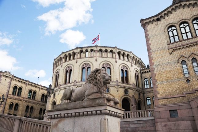 Pictured is one the famous lion statues outside Norway's parliament.