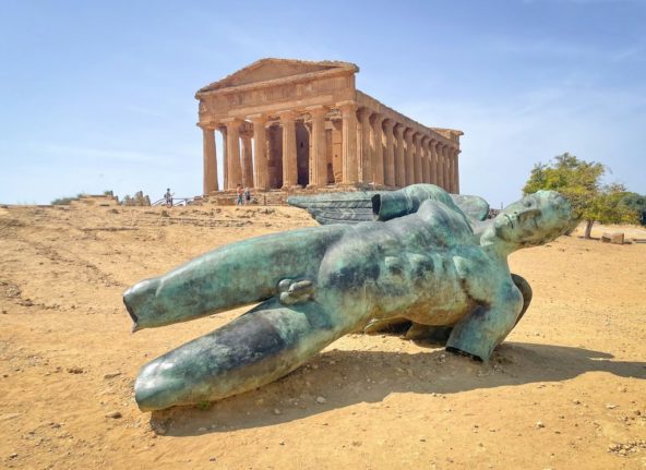 A broken statue of Icarus at the base of the Temple of Concordia in Agrigento.
