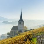 Why do companies in Switzerland have to pay church taxes?