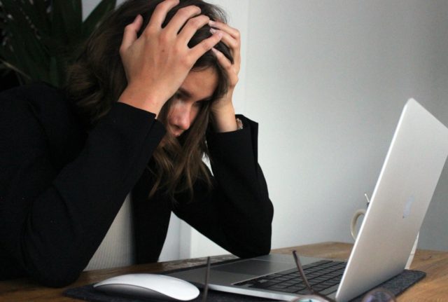 A stressed woman at her computer
