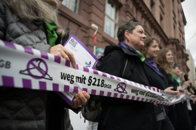 During a flash mob organised by the Alliance for Sexual Self-Determination on Monday, activists hold a ribbon calling for the removal of paragraph 218, which would remove abortion from the criminal code in Germany.
