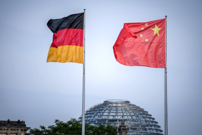 File photo shows the German and Chinese flags flying at the Federal Chancellery at the start of a 2023 Chinese government visit to Berlin.