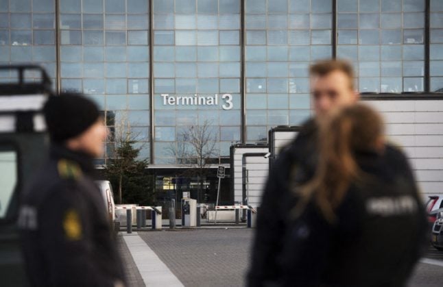 Policemen stand outside terminal 3 at Kastrup airport in Copenhagen