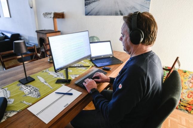 A man working at a computer in his home office