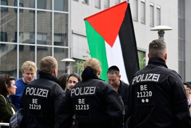 Police officers stand guard in front of the entrance to the venue of the so-called Palestine Conference in Berlin,