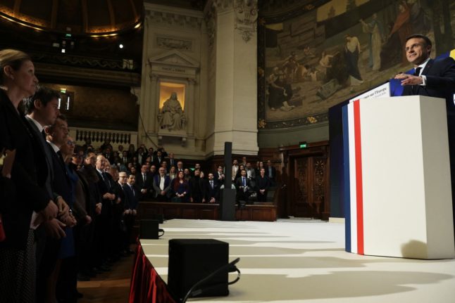 French President Emmanuel Macron (R) delivers a speech on Europe in an amphitheatre of the Sorbonne University in Paris