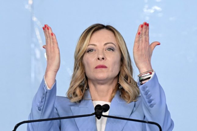 Italy's Prime Minister, Giorgia Meloni gestures on stage during the campaign meeting of the far-right party Fratelli d'Italia