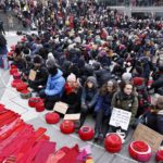 Climate protesters wrap Swedish parliament in giant red scarf