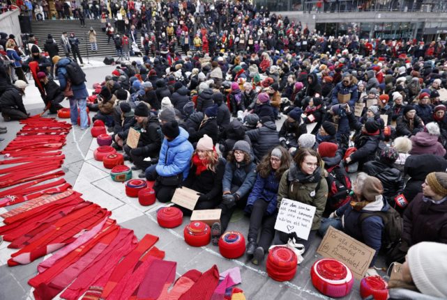 Climate protesters wrap Swedish parliament in giant red scarf