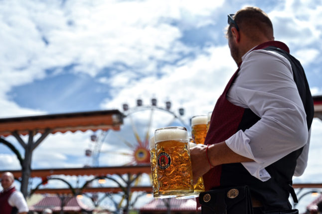 A waiter brings beer at a spring fest in Munich on Friday.