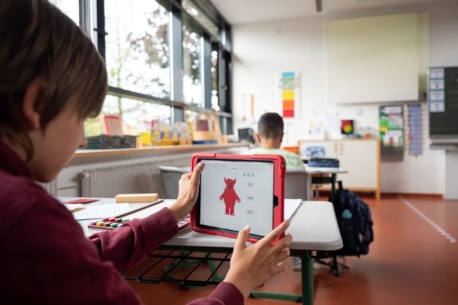 A child in Bavaria uses a tablet during art class.